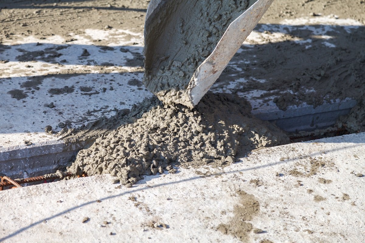 Workers pour the Foundation for the construction of a residential building using mobile concrete mixers